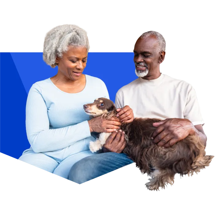 mature couple sitting with their dog