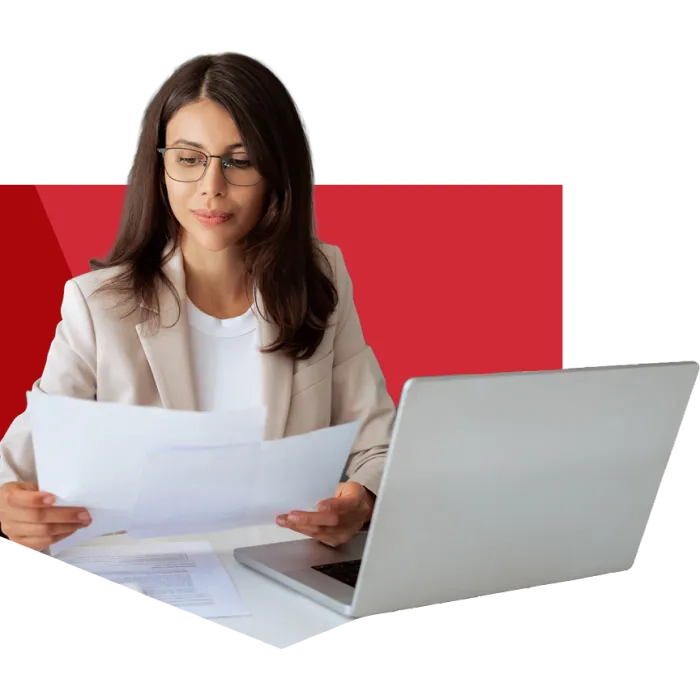 woman at desk reviewing documents