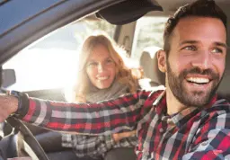 Man driving car with woman passenger