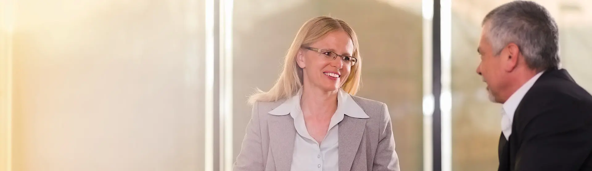 Two business people discussing corporate banking and commercial banking in a meeting