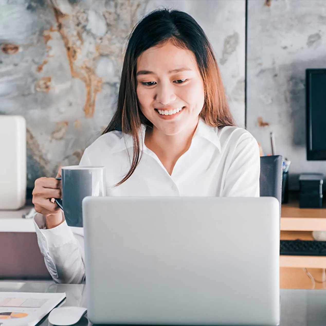 Photo of a person working on a laptop