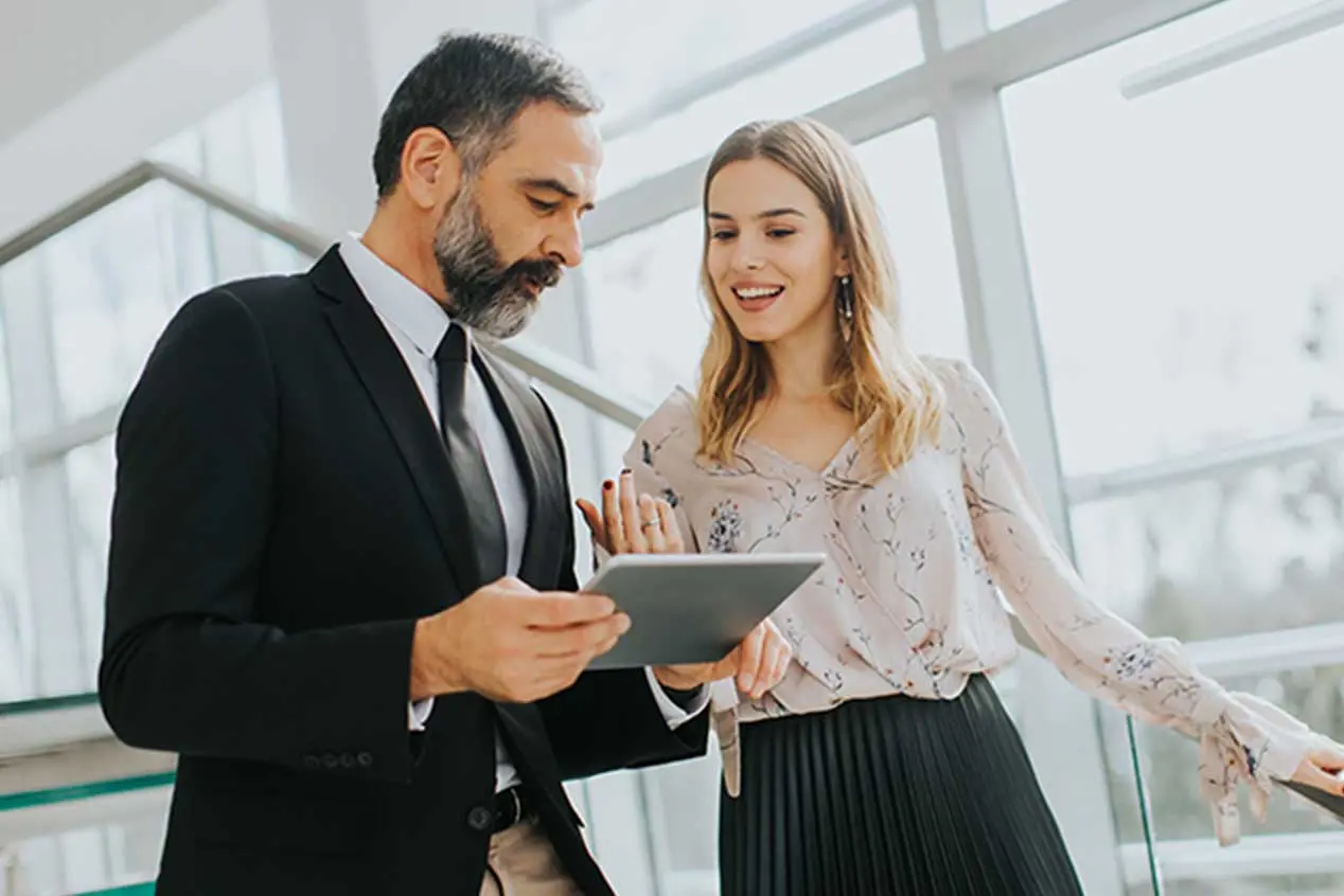 Man and woman discussing liquidity management in their office