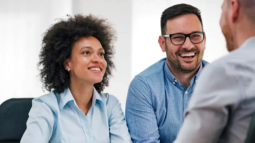 A couple meeting with an advisor to talk about alternative investments