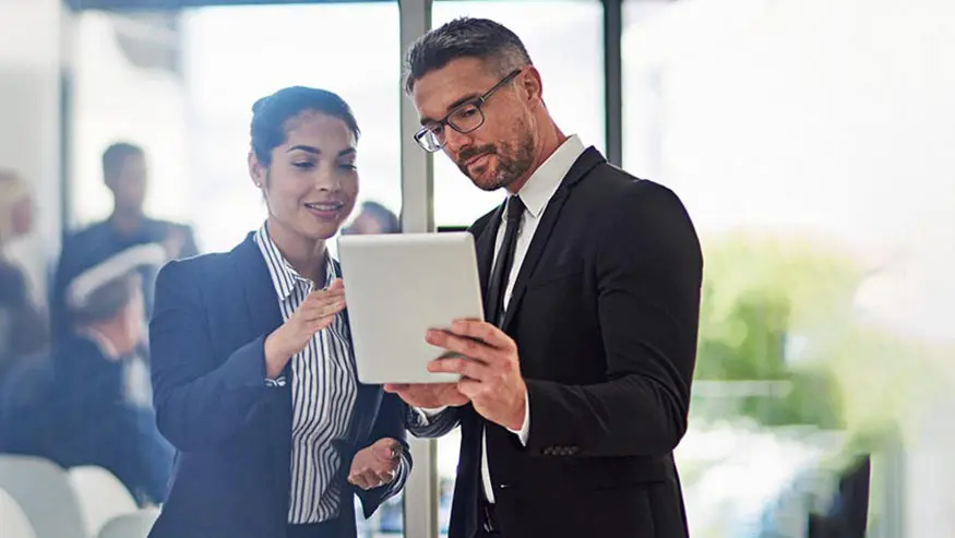 Man and woman looking at tablet at the office