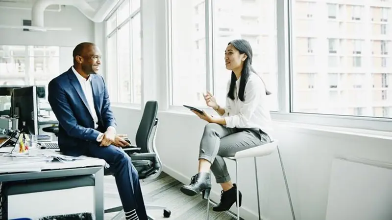Three office workers discussing multiple series trusts for mutual funds