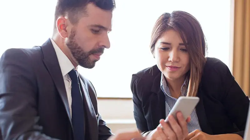 Man and woman looking at smarter faster payment system options