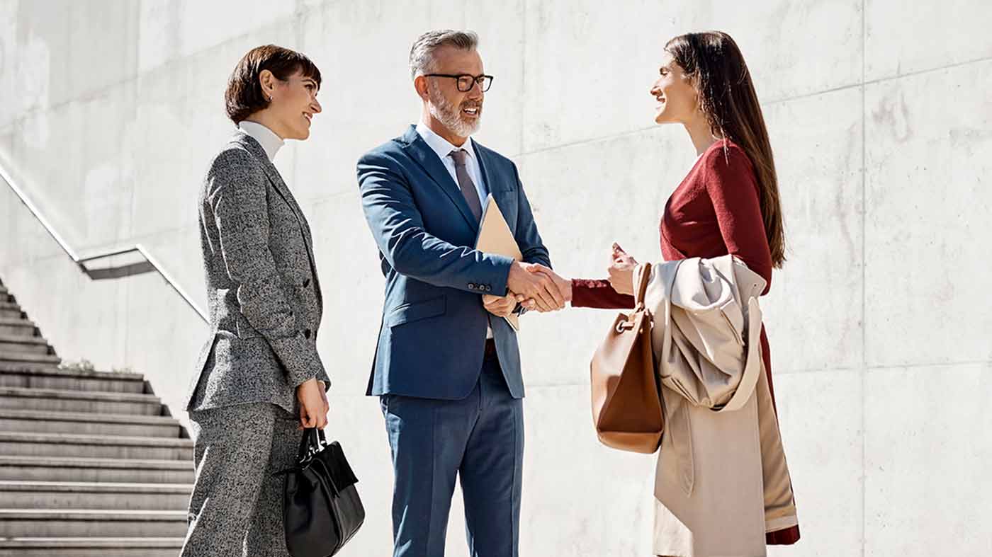 Group of coworkers discussing outside