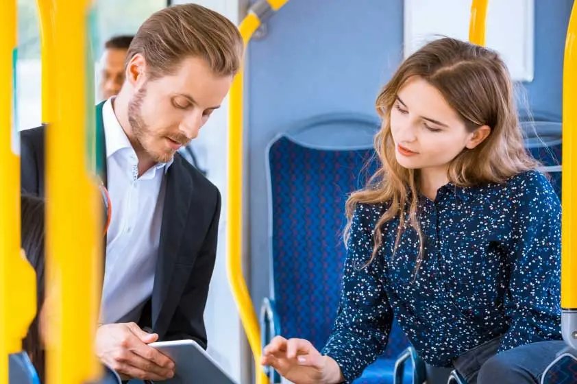 photo man and women riding a train