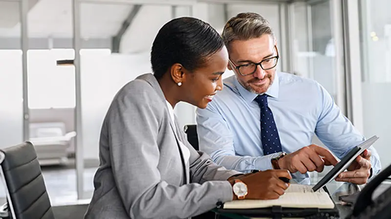 Colleagues discussing new B2B virtual card payment solutions for their business