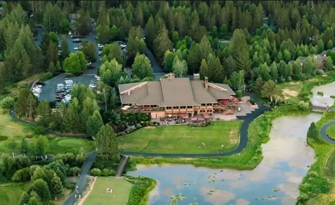Overhead view of the main building at Sunriver Resort with a small pond in front of it
