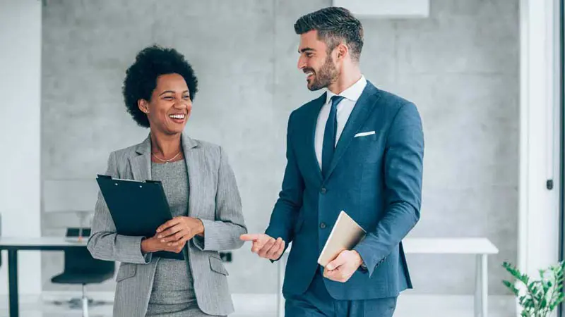 Two professionals walking down the lobby