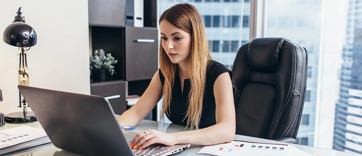 Woman working on a laptop computer.