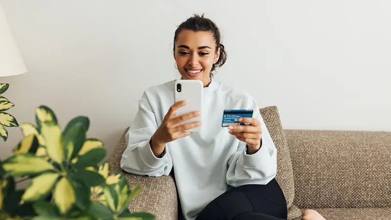 Young woman looking up on the phone