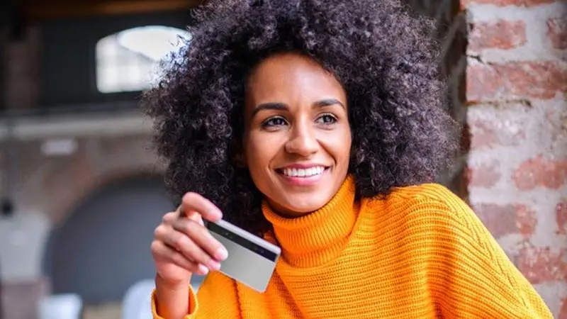 Citizen holding her prepaid card that disburses government funds.