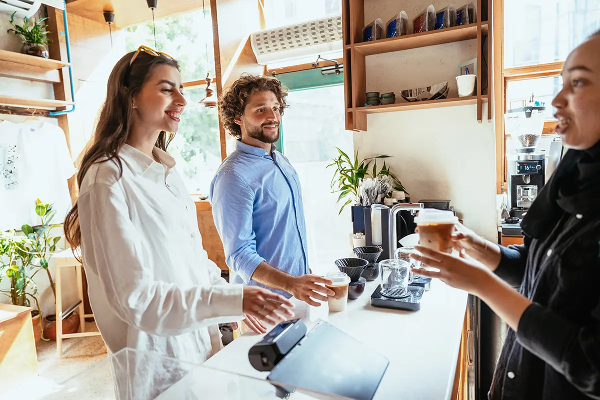 Man and woman at the counter at a coffee shop