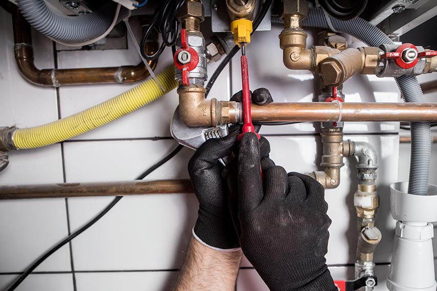 hands working on plumbing