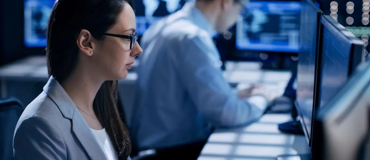 Woman investigating payment fraud at her computer