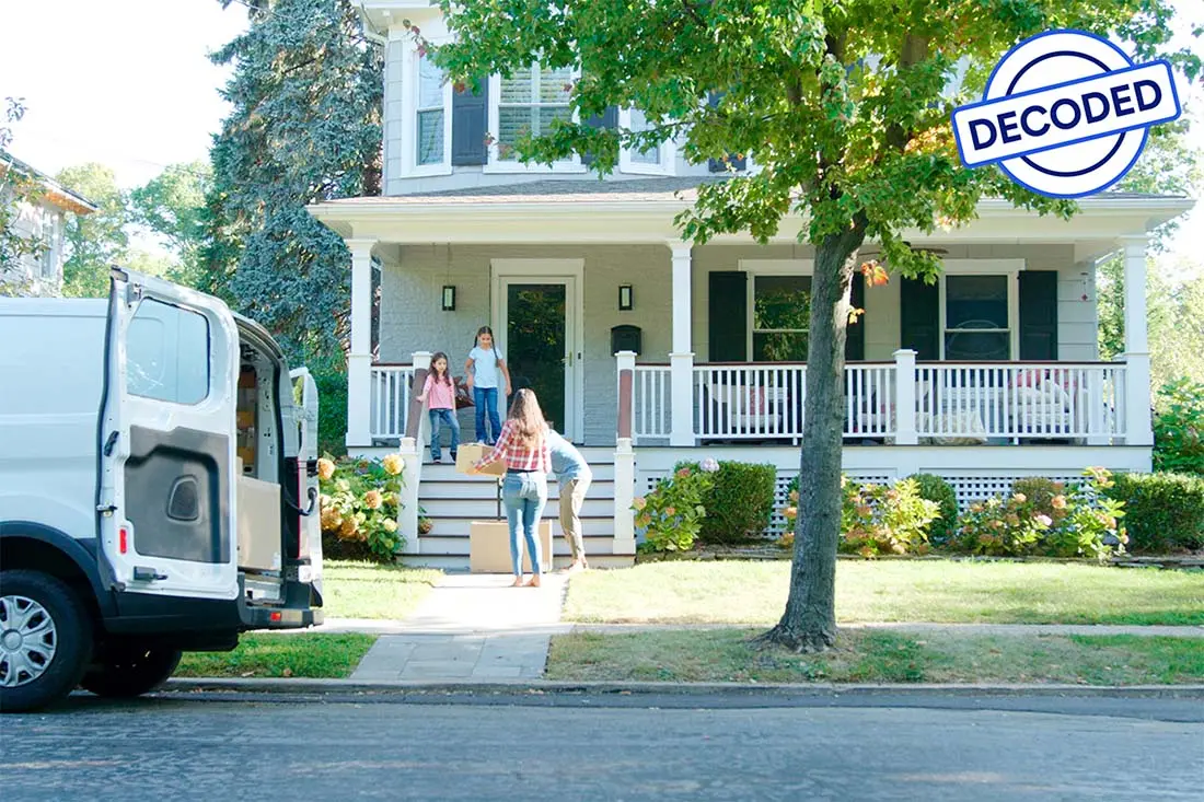 people unloading a moving truck outside a home