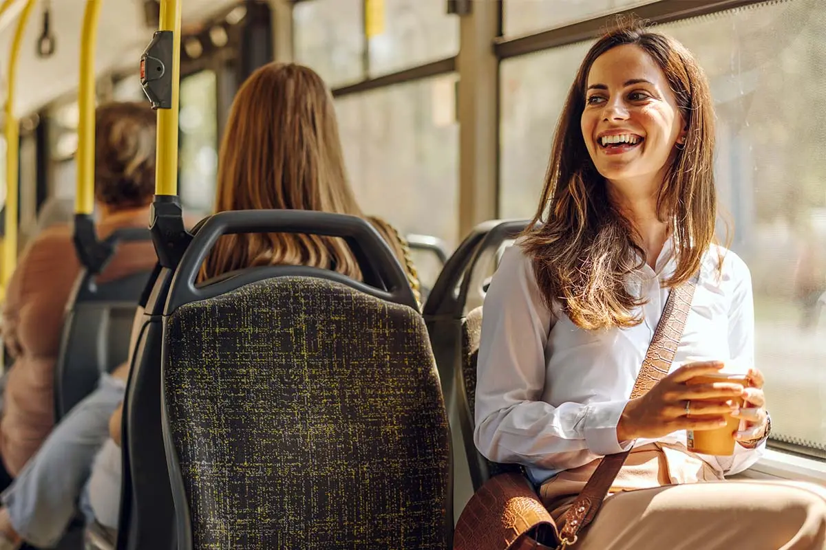 woman on a bus holding a coffee cup