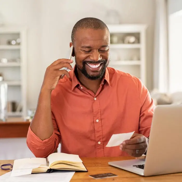 Person on phone reading ABA routing number on a check
