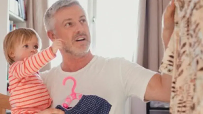 father holding child and pointing