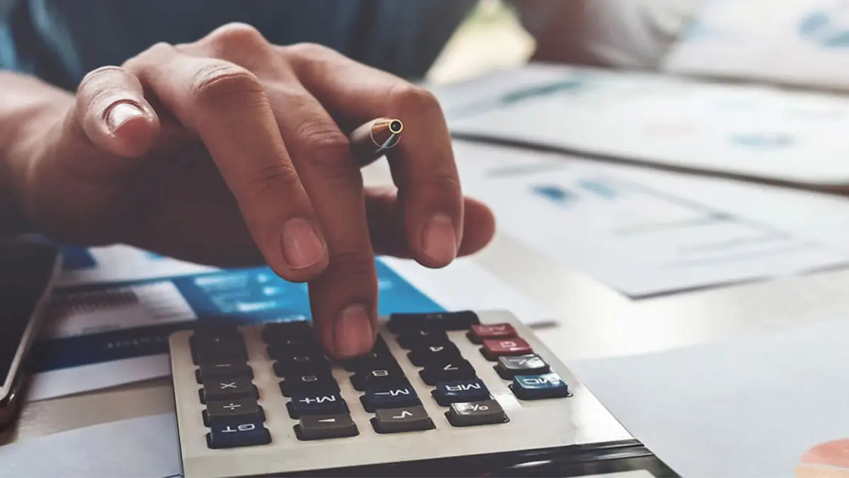 close up of a hand crunching numbers on a calculator