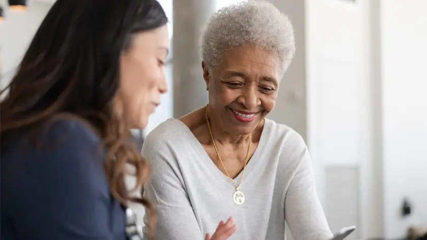 elderly woman meeting with healthcare worker