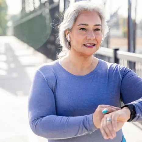 Photo of a women looking at her watch