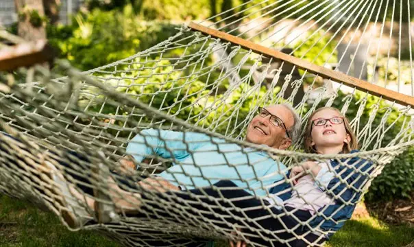 senior couple laying in a hammok