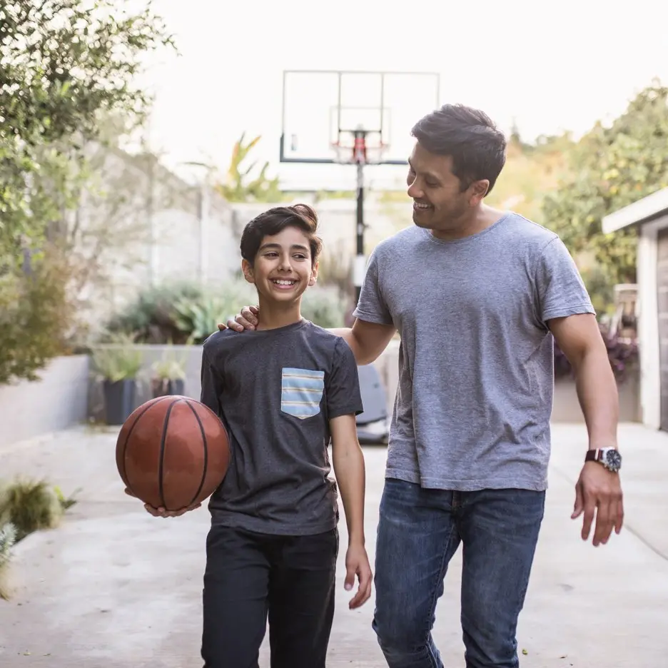 Photo of a father and son are playing basketball