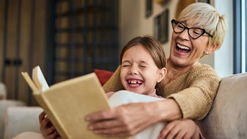 Grandparent and grandchild reading together