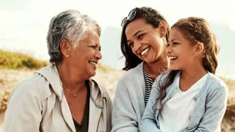 Grandmother, mother and daughter smiling