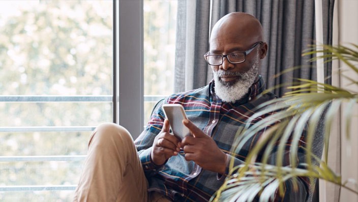 Man reviewing investments on mobile phone