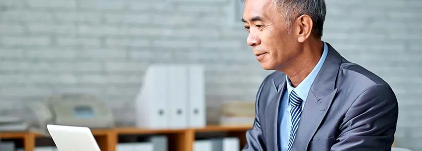Asian man working on computer