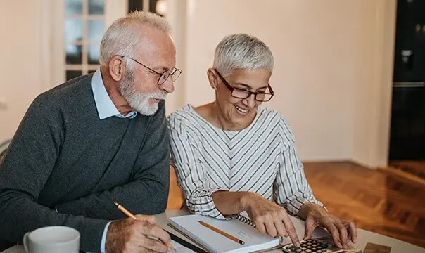 senior couple working on taxes at table