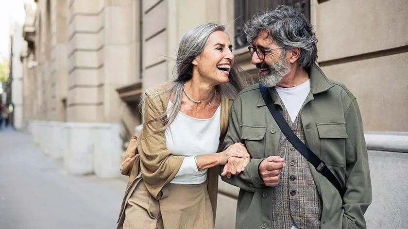 Senior couple walking and smiling