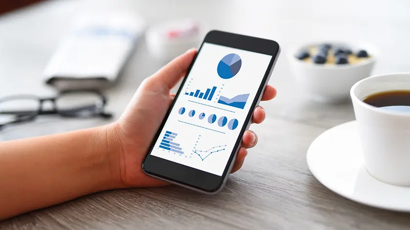 person reviewing stock market on iPad