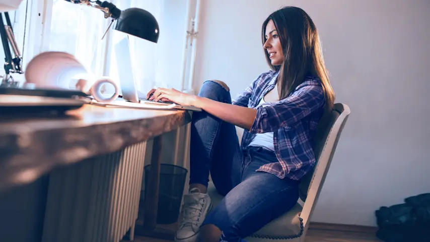 woman sitting at desk working on laptop