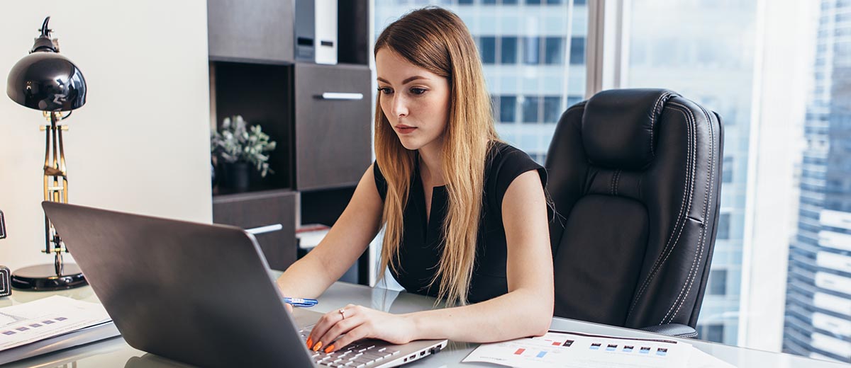 Woman working on a laptop computer.