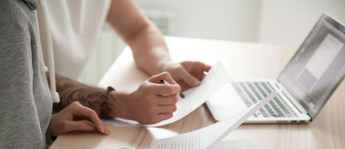 Two people working on paperwork at a table