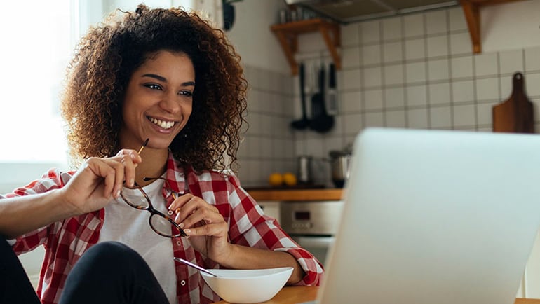 Woman smiling in front of computer