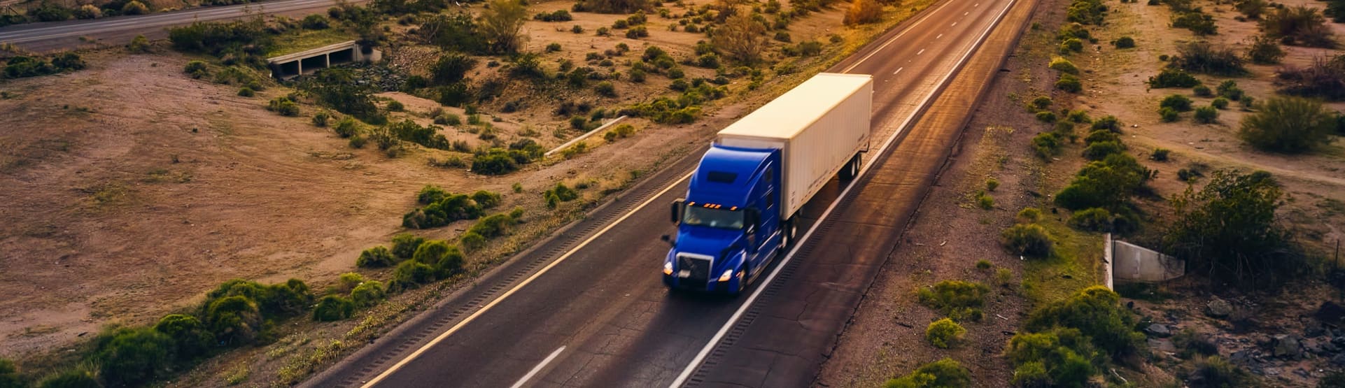 Semi-truck driving down a road