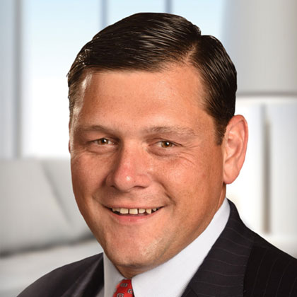 Headshot of Alan Markarian wearing a suit and tie