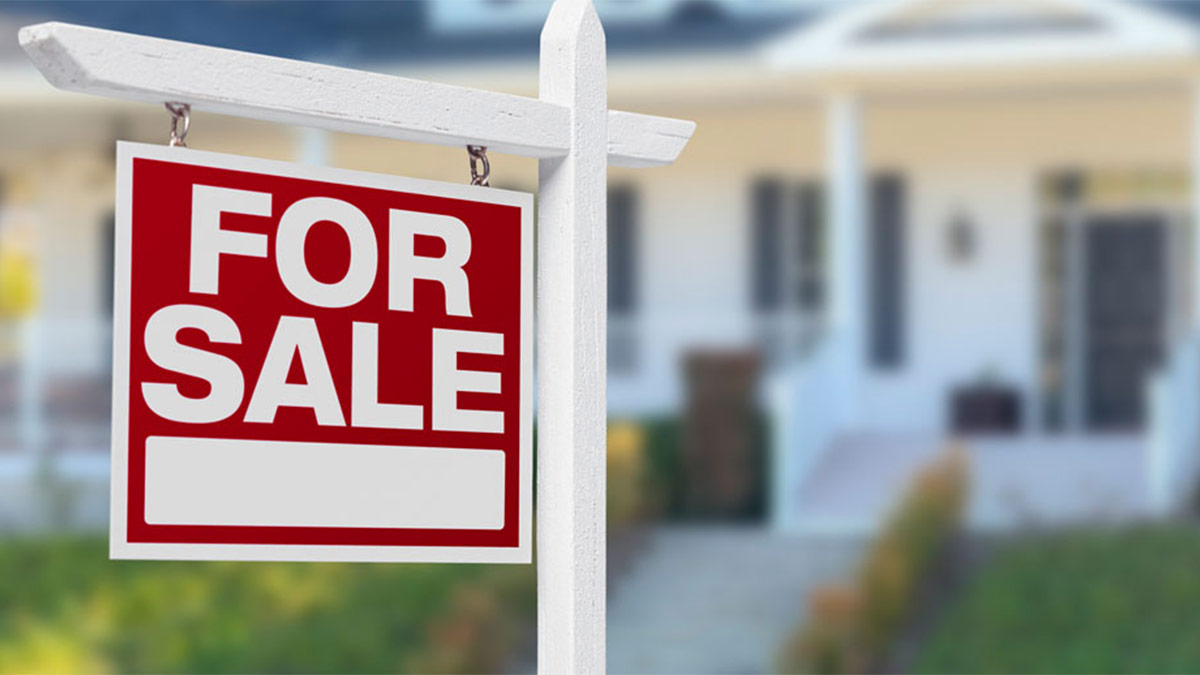 Photo of a For Sale sign infront of a home